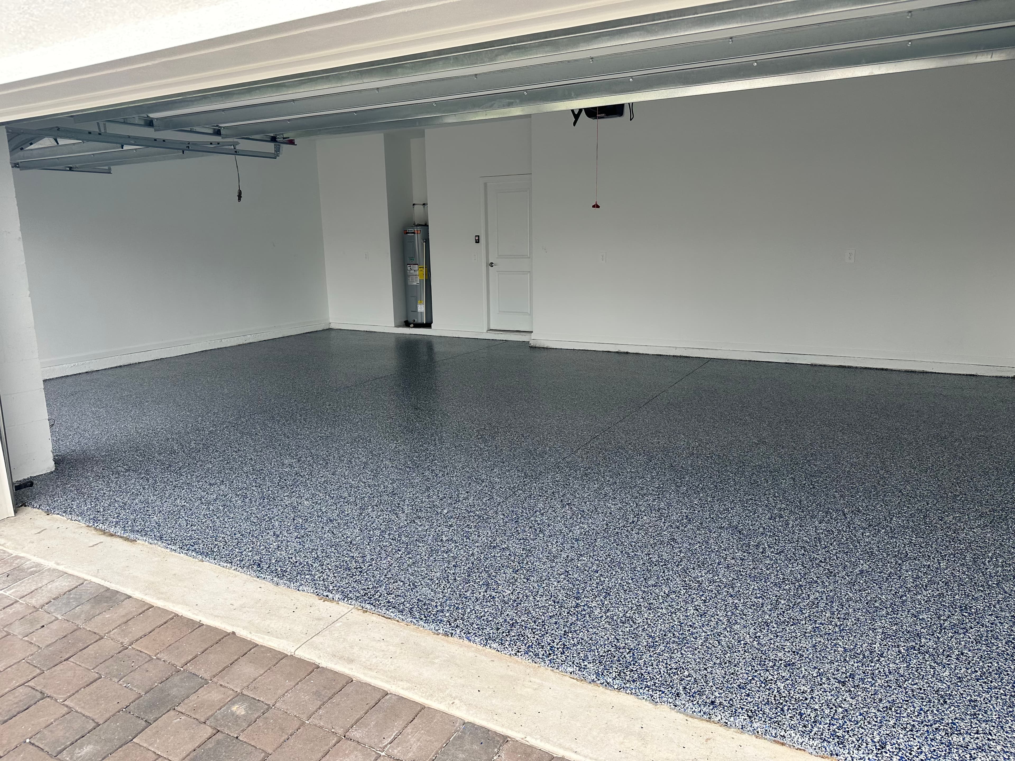 Blue-gray flake epoxy coating installed across a spacious Central Florida garage floor